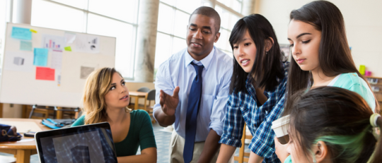 Group of students working together in front of a computer