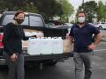 Travis Smith standing next to truck of delivered sanitizer